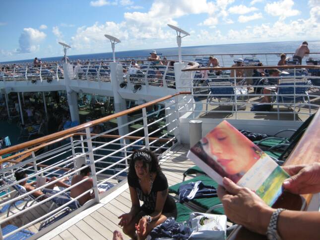 CRUISE SHIP SUNBATHER READING "WIVES"